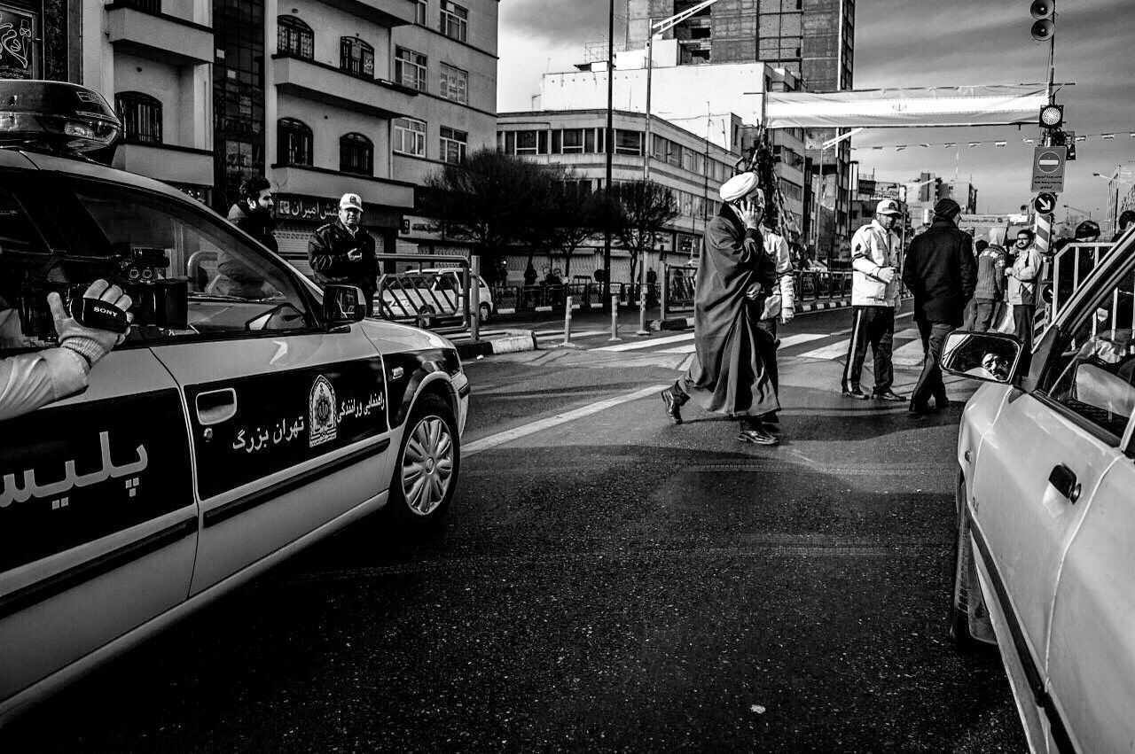 transportation, mode of transport, street, land vehicle, city, architecture, built structure, road, men, city life, building exterior, text, road marking, car, walking, on the move, bicycle, person, lifestyles