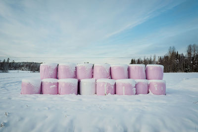 Snow in row against sky during winter