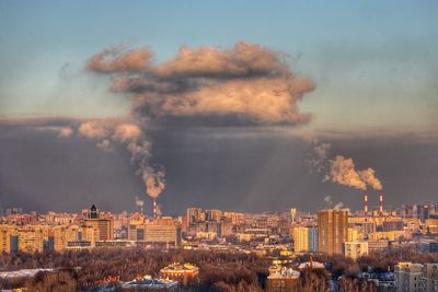 Buildings in city against sky during sunset