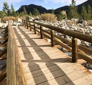 Footpath by railing against sky