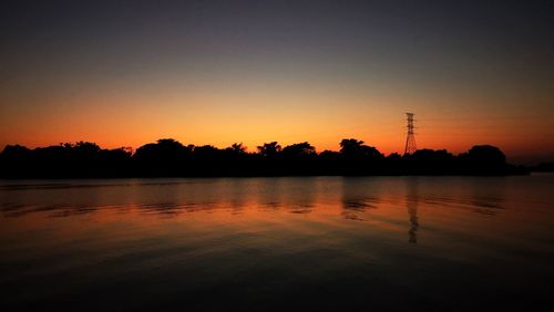 Scenic view of lake against romantic sky at sunset