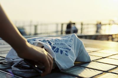 Close-up of hand on book
