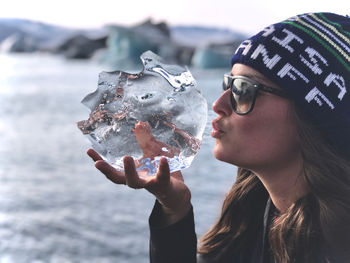 Close-up portrait of young woman holding ice cream