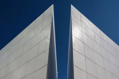 Low angle view of modern building against clear blue sky