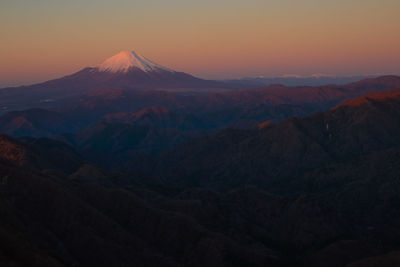 Scenic view of snowcapped mountains against sky during sunset