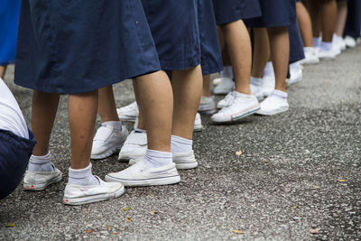 Low section of school students in uniform standing on street