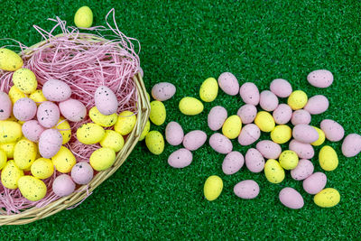 High angle view of multi colored eggs in basket