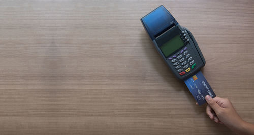 High angle view of person using mobile phone on table