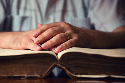 Close-up of man reading book