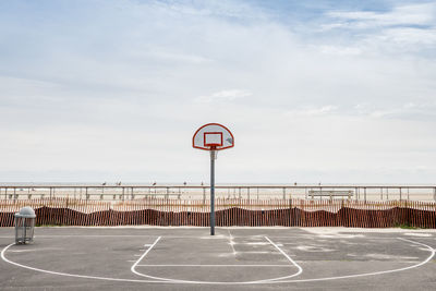 Basketball court against cloudy sky