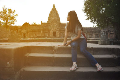 Girl sitting against temple