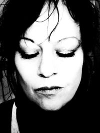 Close-up portrait of young woman with eyes closed