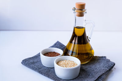Sesame and flax seeds with oil in glass bottle. healthy food concept. vegan keto diet. healthy eat