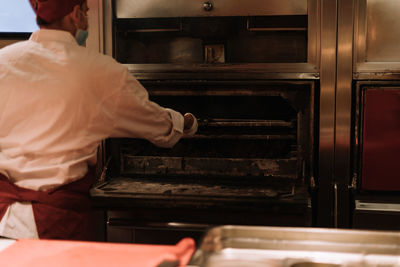 Midsection of man preparing food in kitchen