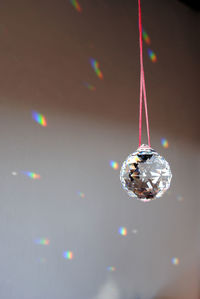 Close-up of crystal ball hanging against wall