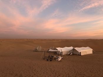 Scenic view of desert against sky during sunset