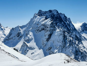 Scenic view of snowcapped mountains against sky