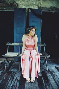 Young woman sitting on statue