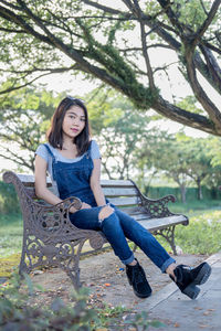 Portrait of young woman sitting on chair