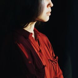 Close-up of woman looking away over white background