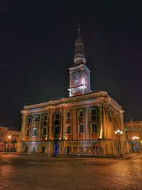 Low angle view of illuminated building against sky at night