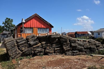 Stacked crab pots by houses in village