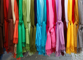 Close-up of colorful shawls hanging at market
