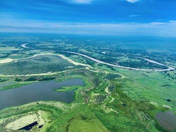 High angle view of river amidst landscape against sky