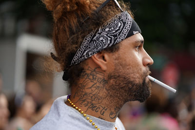 Portrait of young man looking away outdoors