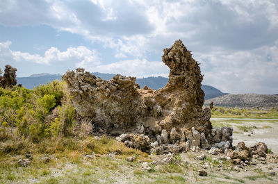 Rock formations on landscape against sky