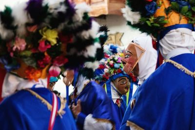 People standing against multi colored flowers