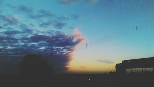 Low angle view of silhouette trees against sky at sunset