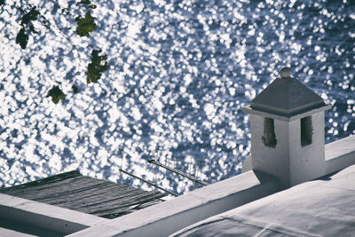 High angle view of house roof sea during sunny day