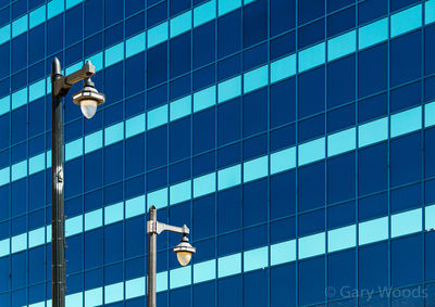 Low angle view of glass building against sky