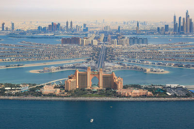 Aerial view of bridge over river against buildings in city