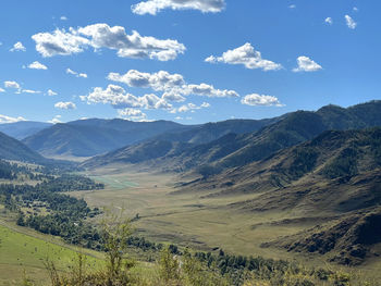 Panoramic view of the mountain plateau and the the road winds along it in altai, russia