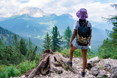 Man standing by plants against mountains