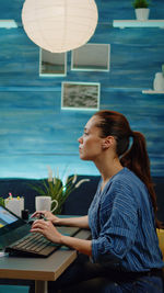 Young woman using laptop at table