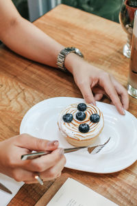 Midsection of woman having breakfast