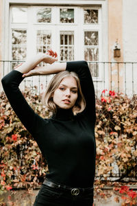 Portrait of young woman in traditional clothing standing outdoors