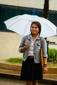 Portrait of woman holding umbrella