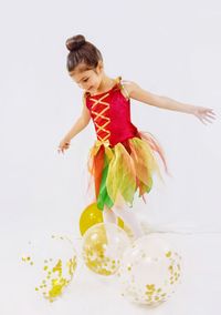 Girl holding ice cream against white background