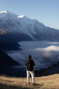 Rear view of woman standing on mountain