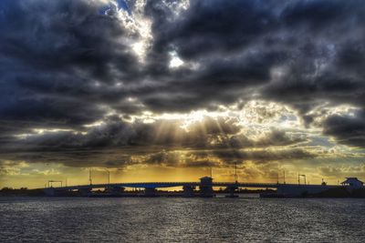 Scenic view of dramatic sky over city during sunset