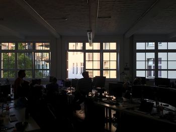 Silhouette people sitting in office