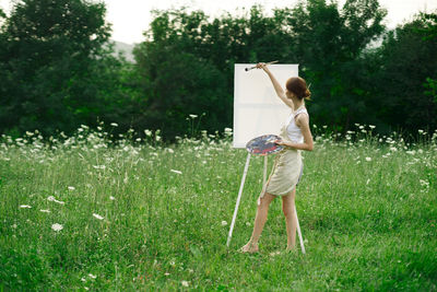 Full length of woman standing on field