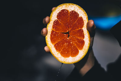 Close-up of orange slices against black background