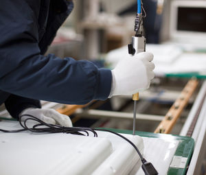 Midsection of man working in factory