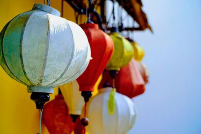 Close-up of colorful lanterns hanging against clear sky