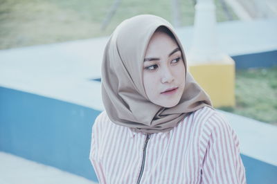 Young woman wearing hijab while standing outdoors